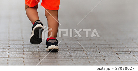 Kid runner feet running on the road in the park, fitness baby running for healthy and relax in the park 57028027