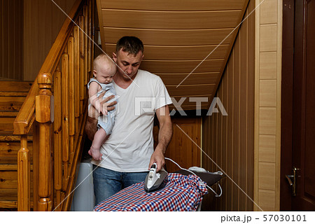 Father with a small baby in her arms ironed linen. Father with a small baby in her arms ironed linen. 57030101