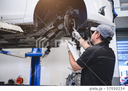 Asian male car technician car maintenance for 57030234
