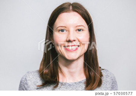 portrait of stylish young pretty Caucasian woman smiling in grey t-shirt on white studio background portrait of stylish young pretty Caucasian woman smiling in grey t-shirt on white studio background 57030577