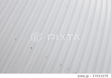 Corrugated fence surface of white metal sheets with screw. Texture of metal fence pattern. Profile 57031070