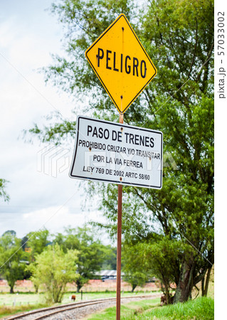 Warning sign in spanish stating do not cross rails Warning sign in spanish stating do not cross rails 57033002
