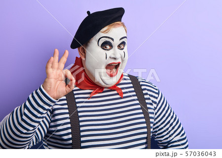 funny fat man in stiped sweater and black beret expresses agreement funny fat man in stiped sweater and black beret expresses agreement 57036043