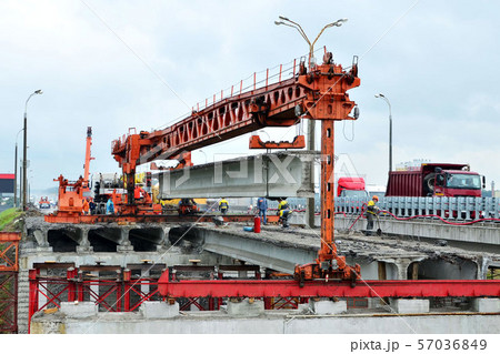 Repair of the automobile bridge over the railway. Mounting crane removes reinforced concrete beams. Repair of the automobile bridge over the railway. Mounting crane removes reinforced concrete beams. 57036849