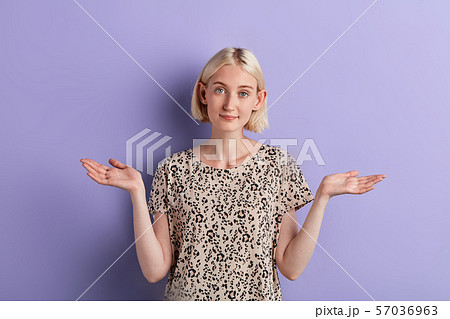 confused young attractive girl shrugging shoulders isolated over violet background 57036963