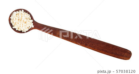 top view of wooden spoon with white sesame seeds 57038120