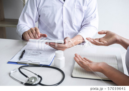 Doctor consulting with patient and checking 57039641