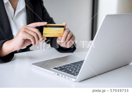 Business woman consumer holding credit card and 57039733