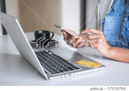 Young woman consumer holding smartphone, credit 57039768