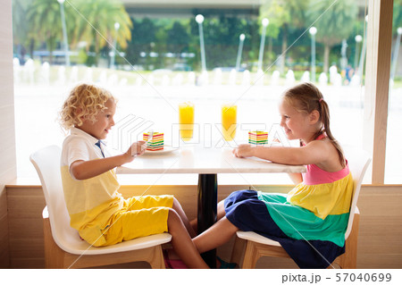 Kids eat cake at restaurant. Boy and girl in cafe. Kids eat cake at restaurant. Boy and girl in cafe. 57040699