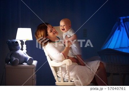 Mother and baby in dark bedroom Mother and baby in dark bedroom 57040761