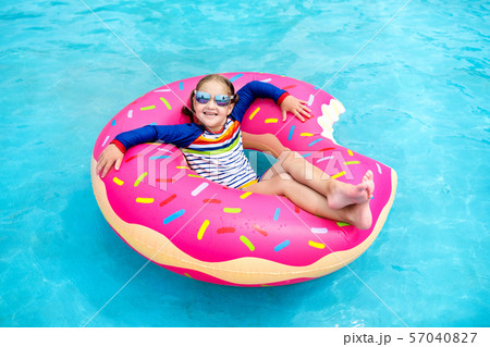 Child in swimming pool on donut float Child in swimming pool on donut float 57040827