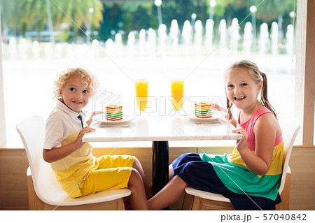 Kids eat cake at restaurant. Boy and girl in cafe. Kids eat cake at restaurant. Boy and girl in cafe. 57040842