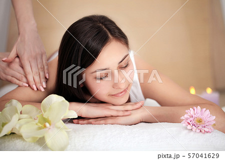 people, beauty, spa, healthy lifestyle and relaxation concept - close up of beautiful young woman 57041629