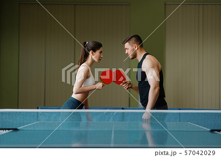 Man and woman on ping pong training indoors Man and woman on ping pong training indoors 57042029
