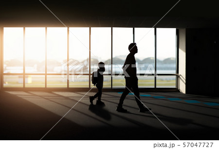 Window with silhouette people at Airport. 57047727