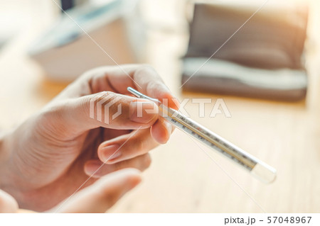 Doctor holding on thermometer for checking sick 57048967