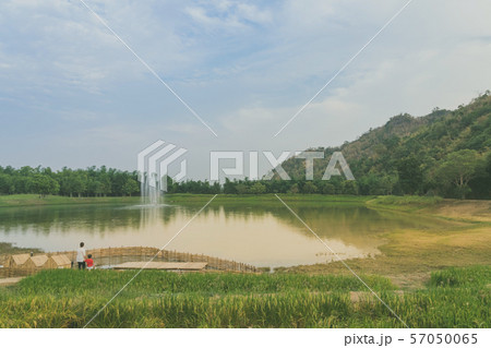Back view of Mom and son are resting and taking care of their ducks in the evening 57050065