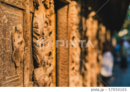 Archaeological, Close Up of carved art figures on old wood carvings on the wall temple at Shwe Nan Daw Kyaung (Golden Palace Monastery) in Mandalay, Myanmar 57050103