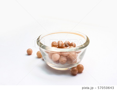 Light orange color sunstone isolated in Glass cup on white background Light orange color sunstone isolated in Glass cup on white background 57050643