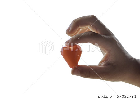 Isolated Hand holding a red candy shape heart on a white background with clipping path. Isolated Hand holding a red candy shape heart on a white background with clipping path. 57052731