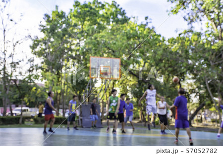 Blurry image of elderly men and teens playing basketball in morning at BangYai Park , Nonthaburi. 57052782