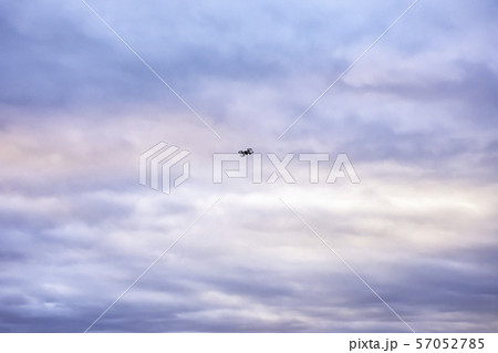 Black drones flying in the sky With many cloud and morning light. 57052785