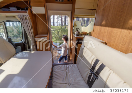 Woman in the interior of a camper RV motorhome 57053175
