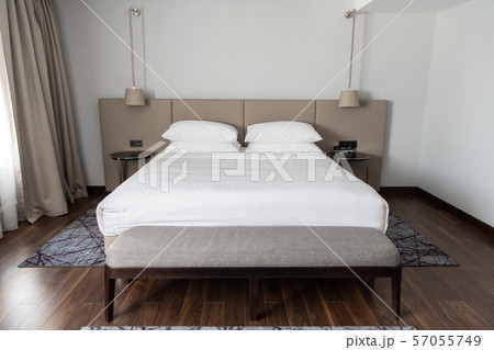 Interior of the modern bedroom in loft flat in light color style of expensive apartments 57055749