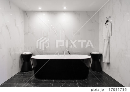 Freestanding black bathtub, stylish minimalist black and white loft style bathroom. Bath, washstand Freestanding black bathtub, stylish minimalist black and white loft style bathroom. Bath, washstand 57055756