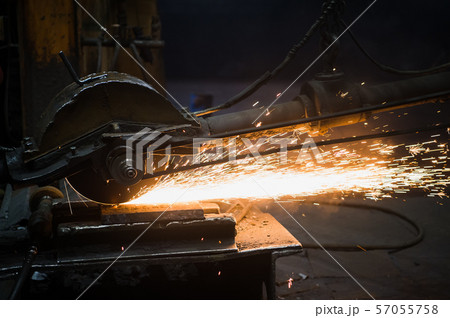 Sparks from circular saw at steel factory. Metal sawing close up. 57055758