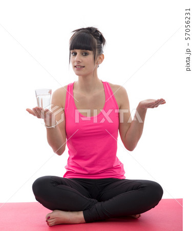 sporty woman in pink sportswear practicing yoga 57056231
