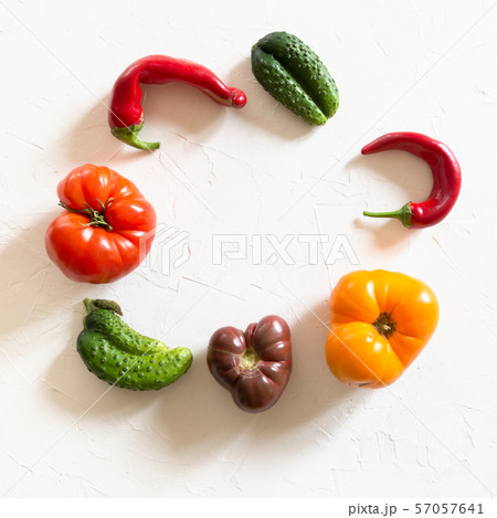 Ugly tomato, pepper, cucumber on white.  57057641