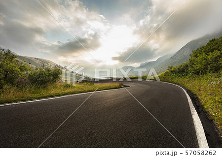 Asphalt road in Dolomites in a summer day. 57058262