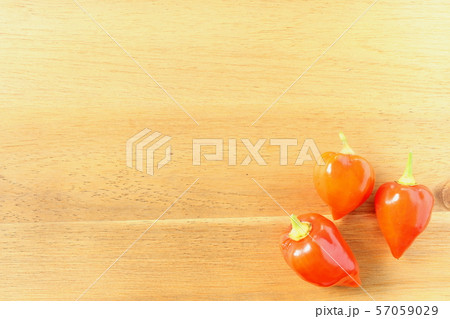 fresh orange ghost chili peppers on a wooden board fresh orange ghost chili peppers on a wooden board 57059029