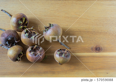 fresh medlar fruits on a wooden board fresh medlar fruits on a wooden board 57059088