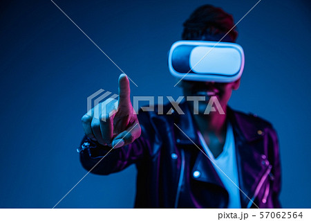 Young african-american woman's using VR-glasses in neon light 57062564