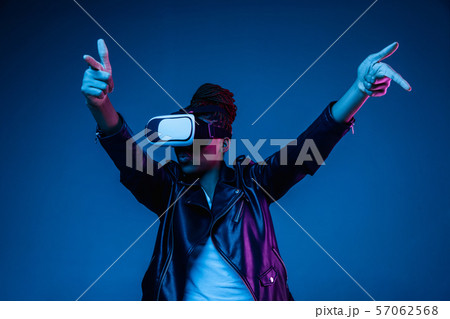 Young african-american woman's using VR-glasses in neon light 57062568