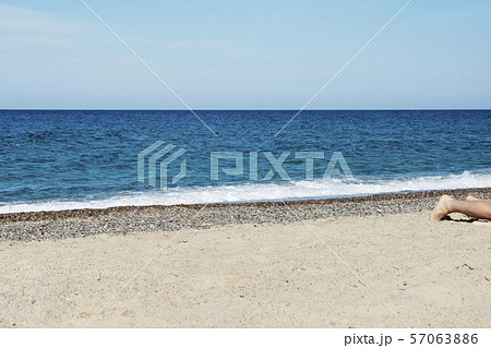 man lying down on the beach man lying down on the beach 57063886