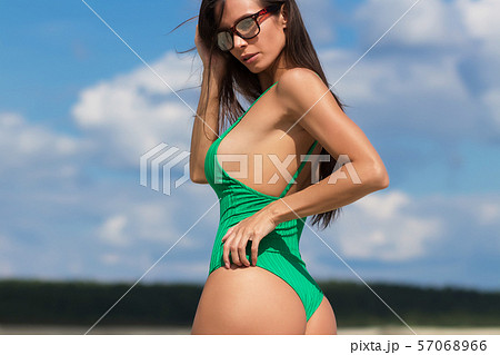 Slim lady in green swimming suit Slim lady in green swimming suit 57068966