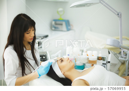 Rejuvenating facial treatment. Model getting lifting therapy massage in a beauty SPA salon Rejuvenating facial treatment. Model getting lifting therapy massage in a beauty SPA salon 57069955