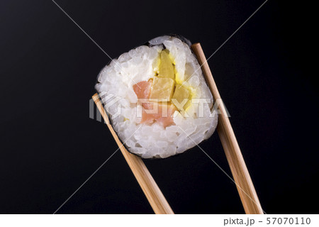 Close-up of sushi roll with salmon on black background 57070110