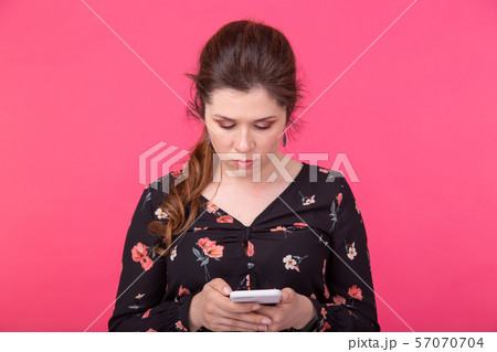 Communication and technologies concept - Portrait of a woman sending text message from her phone on Communication and technologies concept - Portrait of a woman sending text message from her phone on 57070704