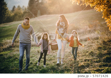 A young family with two small children walking in autumn nature. 57071426