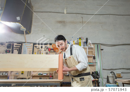 Small-Sized Companies, furniture and worker concept - Handsome young man working in the furniture Small-Sized Companies, furniture and worker concept - Handsome young man working in the furniture 57071943