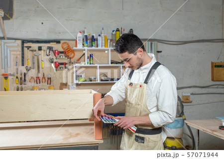 Young bearded man working at the furniture factory, color matching for furniture Young bearded man working at the furniture factory, color matching for furniture 57071944