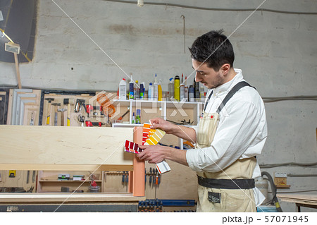 Young bearded man working at the furniture factory, color matching for furniture Young bearded man working at the furniture factory, color matching for furniture 57071945