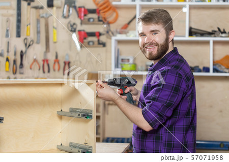 Young bearded man working at the furniture factory 57071958