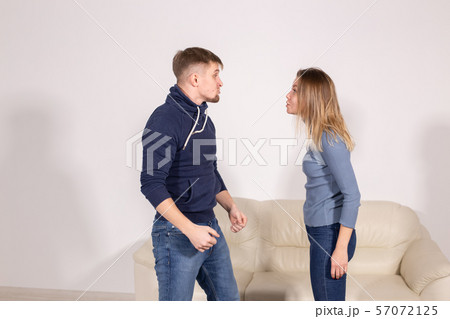people, home violence and abuse concept - young couple screaming to each other 57072125