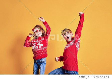Children in warm red Christmas sweaters 57072173